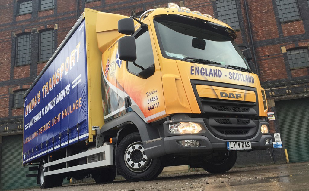 Lynda's Transport yellow haulage vehicle outside an industrial building