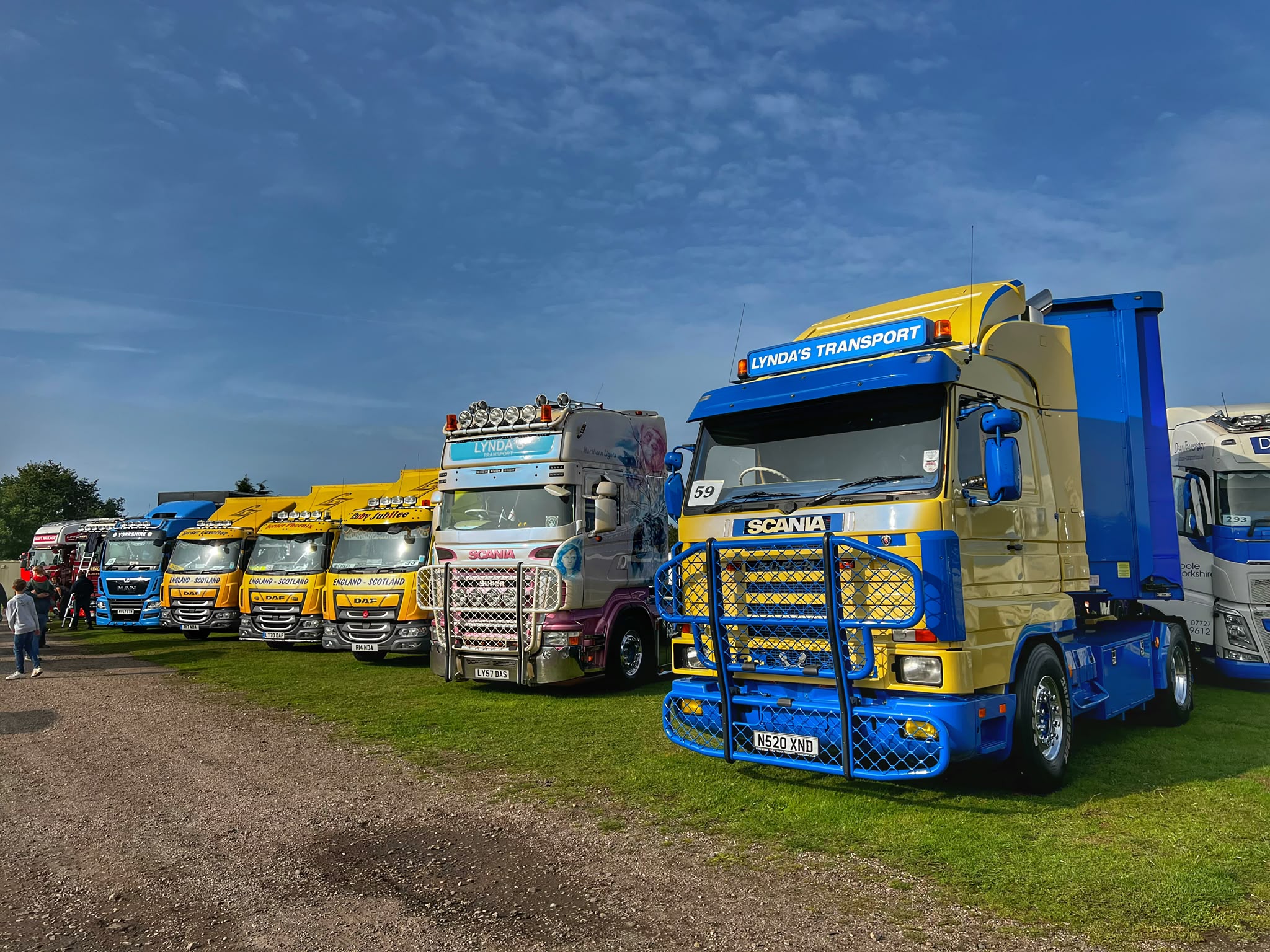 Line-up of Lynda's Transport vehicles at a truck show