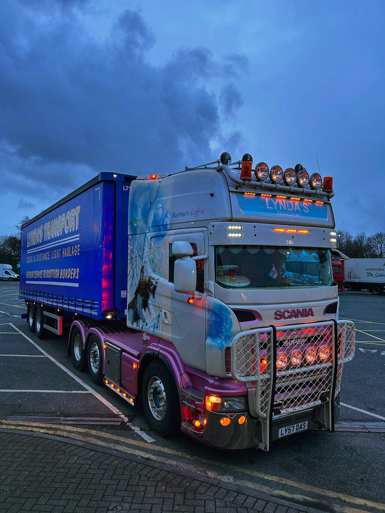 Northern Lights Lynda's Transport truck lit up at dusk