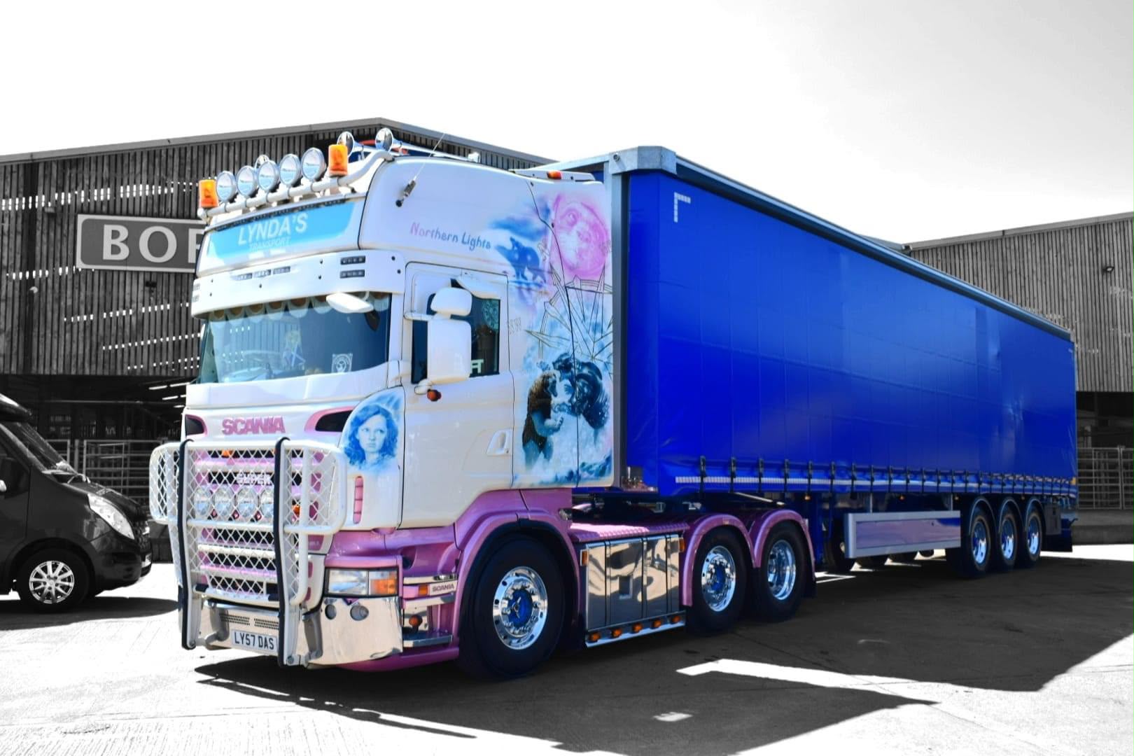 Northern Lights Lynda's Transport truck with a blue curtainside trailer